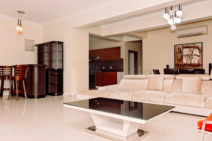 a living room filled with furniture and a table